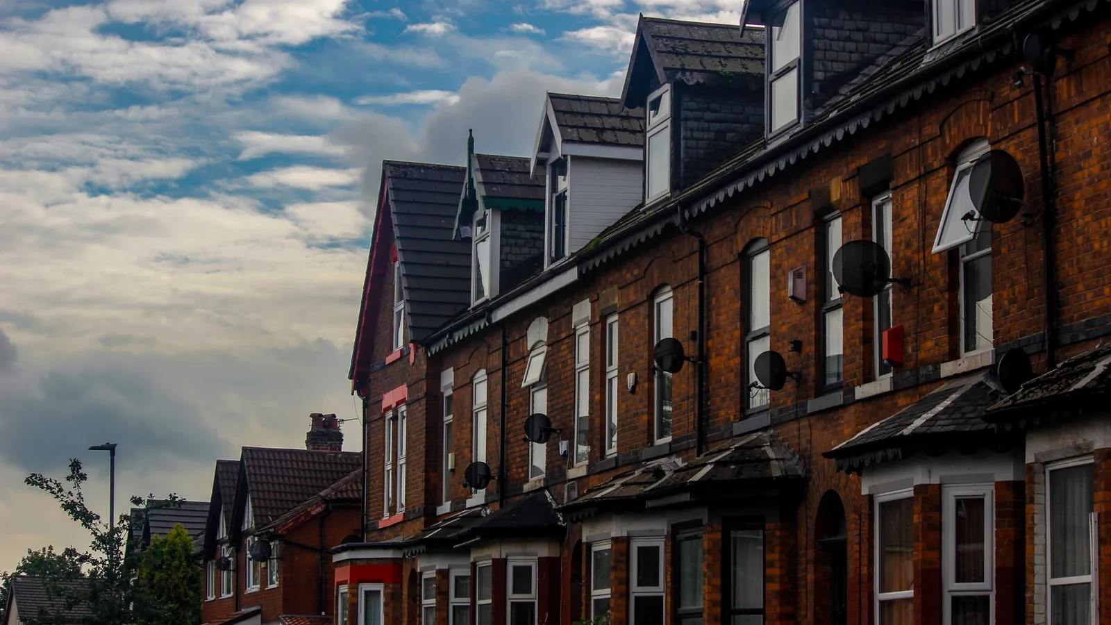 Row of traditional brick terraced houses, the kind of older housing stock common across Ammanford and the Amman Valley