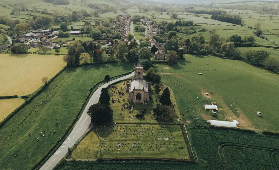 A rural village and its parish church surrounded by open countryside, the kind of setting Llandybie sits in